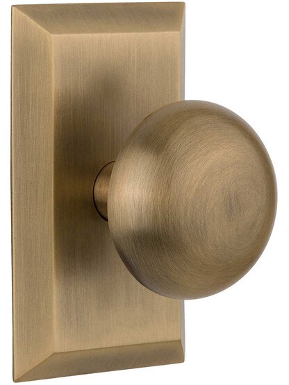 New York Rosette Door Set with Classic Round Knobs in Antique Brass.